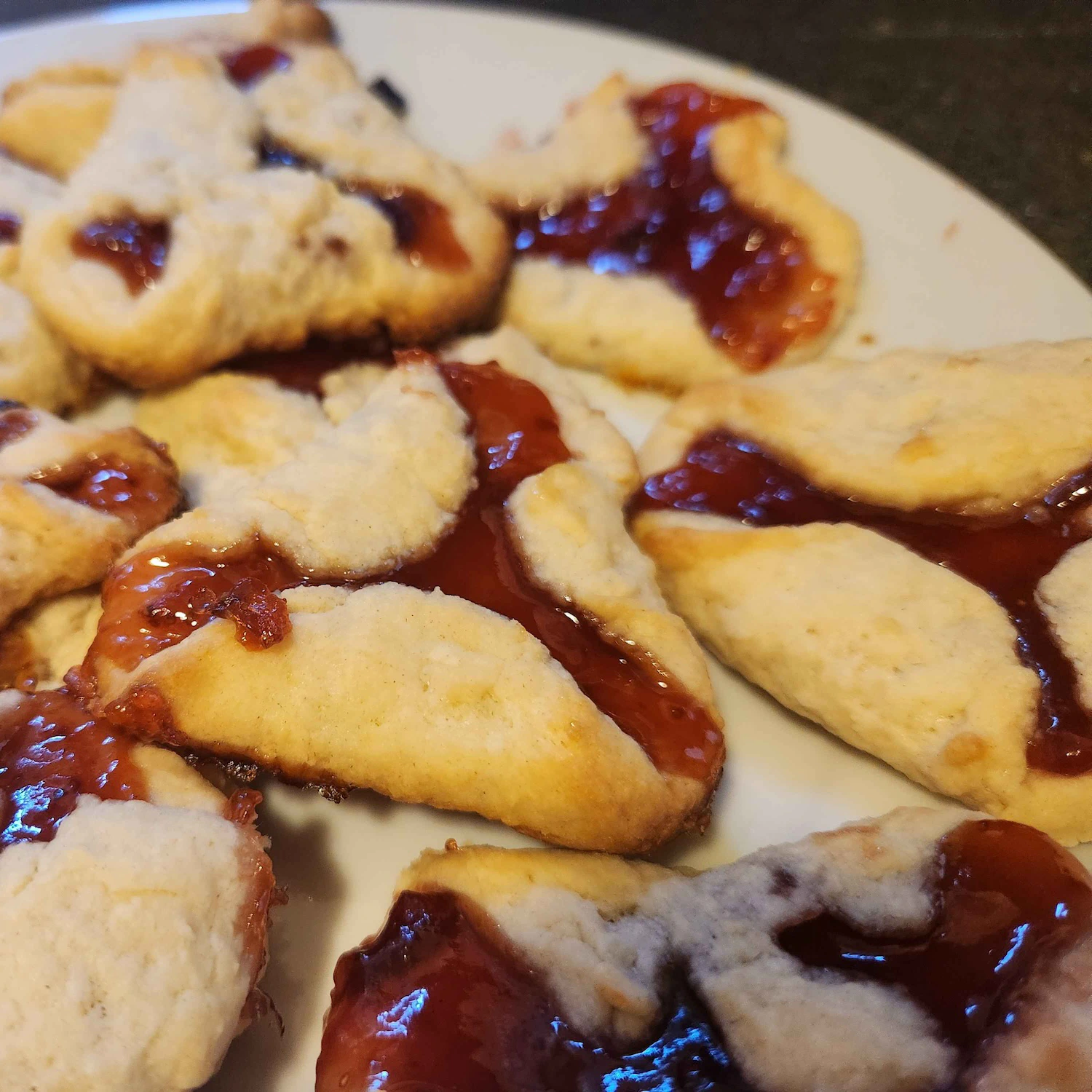 Seven more super flat tarts on a plate.