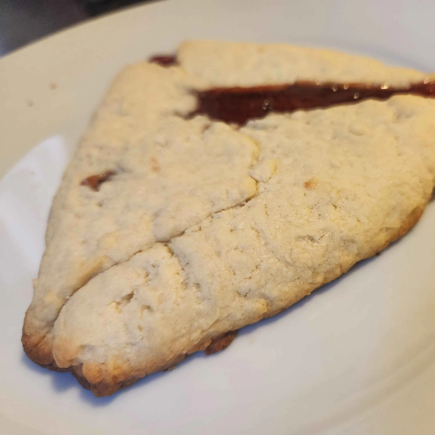 The mega-tart sitting on a plate after baking, looking very flat.